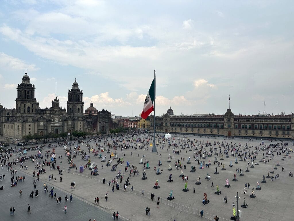 The Zócalo, Plaza de la Constitución, in Mexico City with the giant Mexican flag, the Metropolitan Cathedral, and the National Palace